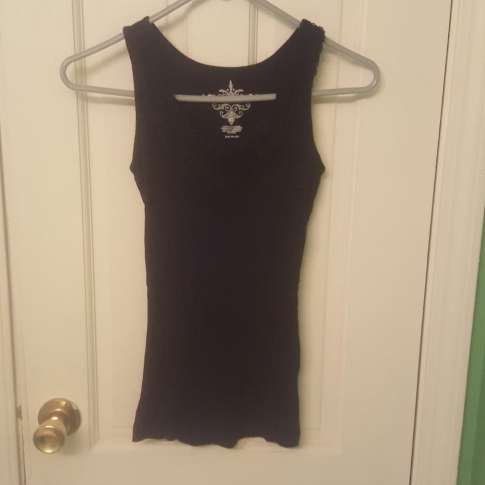 black tank with embleshiments around neckline